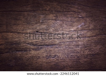 Beautiful patterned and textured background of dark brown old wood.