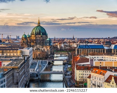 Aerial shot of Berlin Cathedral, Spree canal and historic buildings during asunset, Germany