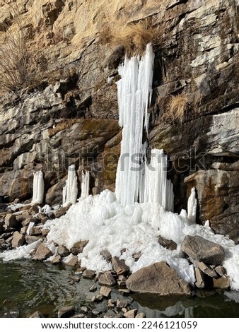 Frozen waterfall out of rock wall
