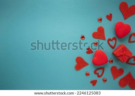 beautiful valentine's day concept with copy space - Red hearts and Gifts on blue background.