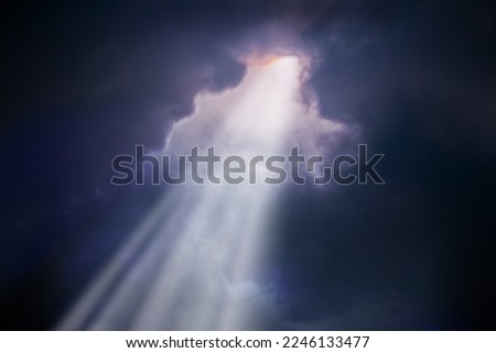 A bright sunbeam breaks through the dark clouds. Concept of hope Royalty-Free Stock Photo #2246133477