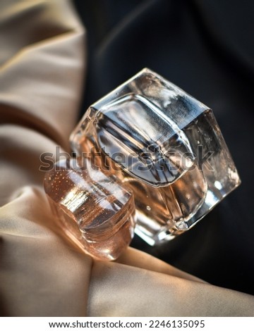 Parfume on black and gold silk background. High quality photo