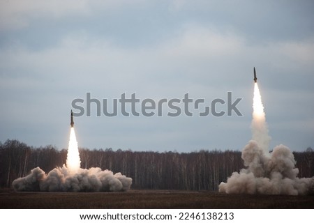 Launch of military missiles (rocket artillery) at the firing field during military exercise Royalty-Free Stock Photo #2246138213
