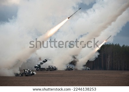 Launch of military missiles (rocket artillery) at the firing field during military exercise Royalty-Free Stock Photo #2246138253