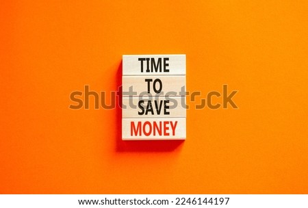Time to save money symbol. Concept words Time to save money on wooden blocks on a beautiful orange table orange background. Business, finacial and time to save money concept. Royalty-Free Stock Photo #2246144197