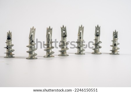 metal galvanised wall plug anchors with screw thread and cross head screw isolated on a white background