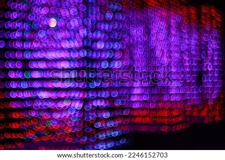 Multicolored Christmas bokeh on a black background. Abstract background. soft focus