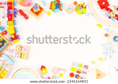 Baby kids toy background. Wooden educational, musical, sensory, sorting and stacking toys, abacus, train, rainbow, colorful building blocks on white background. Montessori toys. Top view, flat lay