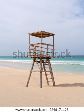 Nice life guard tower by the ocean. Empty bay watch tower with no people. Tower meant for life guard to check the beach and keep everyone safe.  Wooden construction on the beach