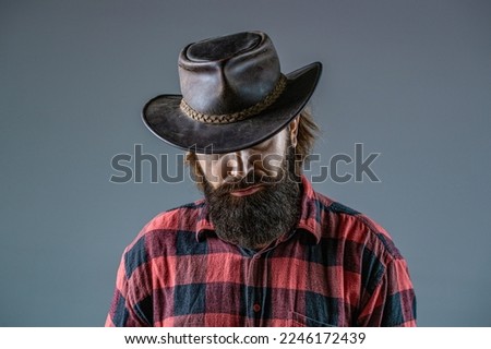 American cowboy. Leather Cowboy Hat. Portrait of young man wearing cowboy hat. Cowboys in hat. Handsome bearded macho. Man unshaven cowboys.