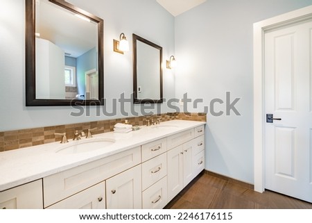 Primary master bathroom with luxury finishing cabinets granite interior room lakehouse Royalty-Free Stock Photo #2246176115