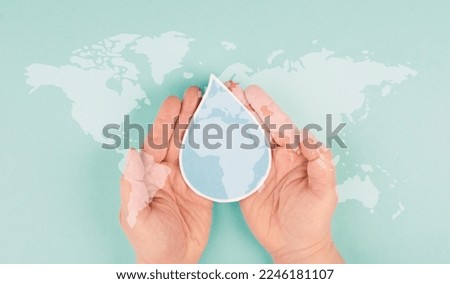 Holding a waterdrop in the hands, silhouette of world map, environment issue, scarcity of resources, world water day Royalty-Free Stock Photo #2246181107