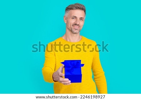 happy man shopper with present isolated on blue. man shopper with present in studio.