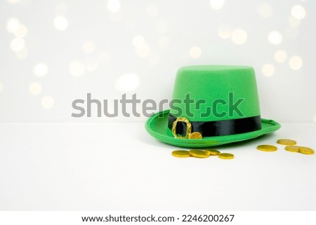 Background banner framed border backdrop. St Patrick's Day product mockup. Styled with green leprechaun hat and gold coins against a bokeh party lights background. Negative copy space.