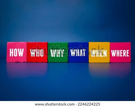 Colored cube with the word WHERE,WHO,WHAT,WHEN,WHY and HOW on blue background.