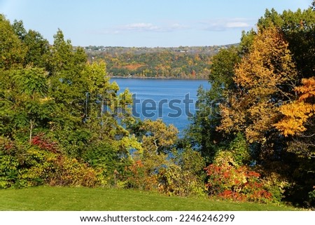 A distance water view with the background of fall foliage near Cayuga Lake, New York, U.S.A
