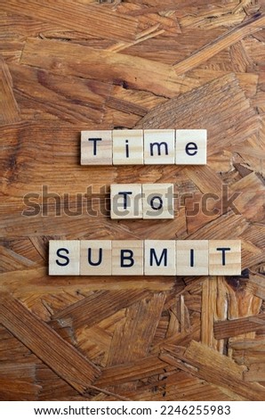Time to Submit text on wooden square, business inspiration quotes