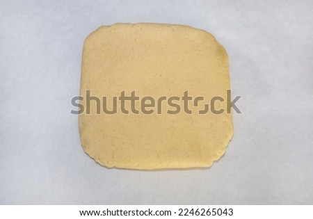 Top view of a chilled sugar cookie dough disk ready to be rolled.