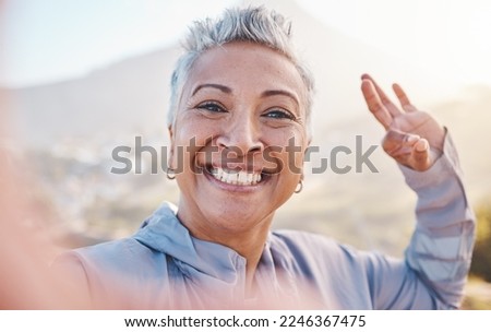 Elderly woman runner, exercise selfie and smile in nature for fitness, wellness or self care with OK hand sign. Happy senior black woman, profile picture and running by mountains, outdoor and workout