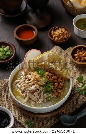 Bubur ayam or Indonesian rice porridge served with shredded chicken, soya beans, celery and leeks Royalty-Free Stock Photo #2246368071
