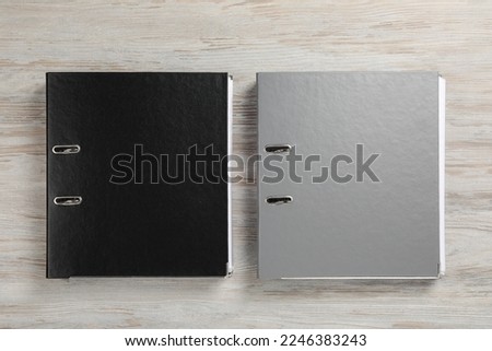 Office folders on wooden table, flat lay Royalty-Free Stock Photo #2246383243