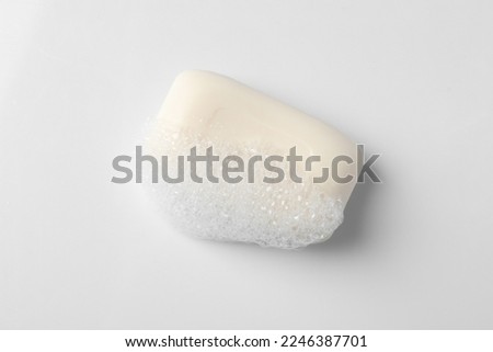 Soap with fluffy foam on white background, top view Royalty-Free Stock Photo #2246387701