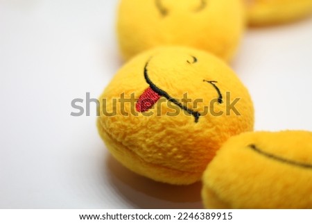 a yellow emoticon doll, isolated on white backgrounda yellow emoticon doll, isolated on white background
