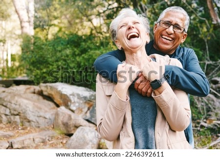 Hiking, laugh and romance with a senior couple hugging while in the woods or nature forest together in summer for a hike. Fun, joke and bonding with a mature man and woman enjoying retirement outdoor Royalty-Free Stock Photo #2246392611