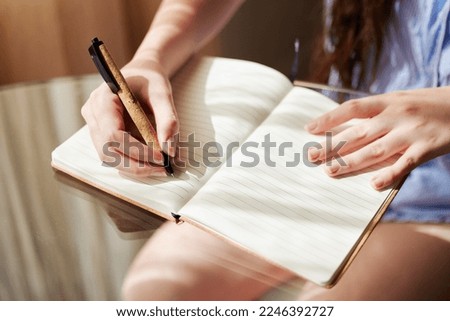 Notebook, hands and woman with pen, journal and reflection with creative, ideas and thinking for writing. Writer closeup, inspiration and write list, planning and brainstorming with notes and paper