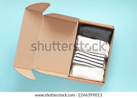 Craft Cardboard Box Container with socks on the blue background