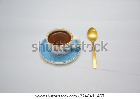 Turkish coffee in elegant and traditional porcelain blue and white dainty floral china ceramic tea coffee cup and saucer set with gold spoon  Mock up design set of drinkware isolated 