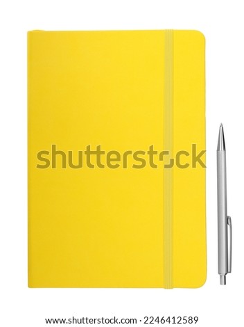 Closed yellow notebook with pen isolated on white, top view