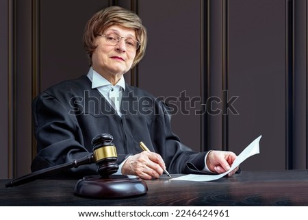 Judge signing the verdict. Judge's gavel on the table in the courtroom. Law Lord wearing gown using a hammer for attention, justice judgment at courts of law. Royalty-Free Stock Photo #2246424961