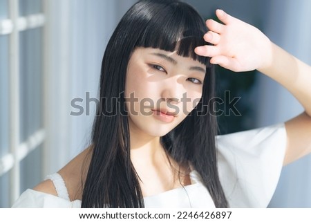 Young Asian woman in the sun. Skin care. UV care. Sunscreen. Royalty-Free Stock Photo #2246426897