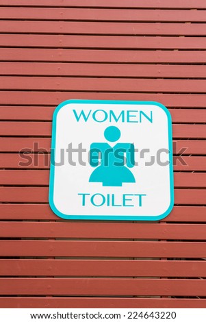 toilet signs of woman on brow wood