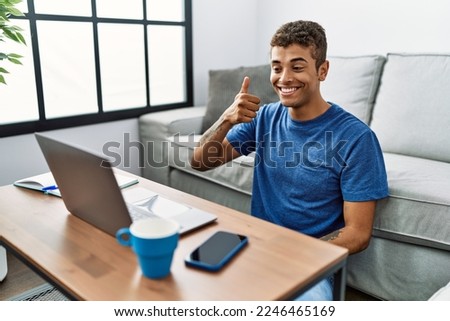 Young hispanic man gesturing sign language on video call at home Royalty-Free Stock Photo #2246465169