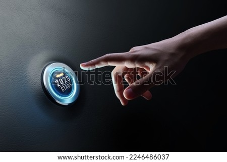 Hand of human going to press on start engine car button on black leather, happy new year 2023 start new project, 3D rendering. Royalty-Free Stock Photo #2246486037