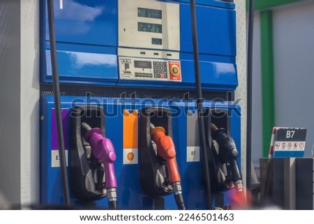 The fuel dispenser has black and gold nozzles lined up.Diesel fuel,gasoline and gasohol dispenser There is a display of the price of fuel at the fuel dispenser.Gas station.Fuel pump at station. Royalty-Free Stock Photo #2246501463