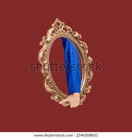Contemporary art collage. Creative design. Abstract art with female hand inside vintage golden mirror over dark red background. Concept of surrealism, imagination, retro, inspiration, artwork. Royalty-Free Stock Photo #2246508833