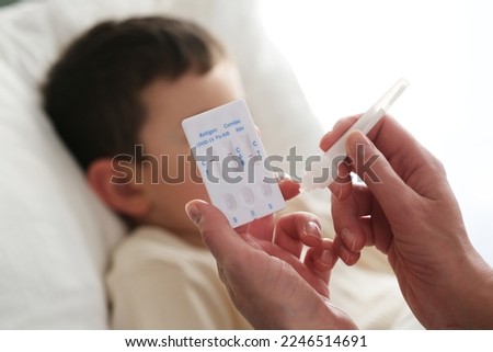 A little boy is sick, a combo antigen test (covid-19, flu a b, RSV) is needed for proper diagnosis. Royalty-Free Stock Photo #2246514691