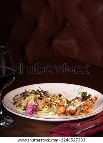 Grilled cabbage and chicken in restourant, with red wine . gold paper on chicken 