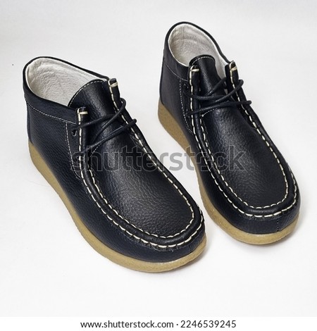 Black boots for women made of natural leather. Black shoes on white background. Leather shoes