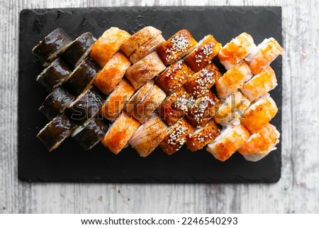 Assorted japanese sushi rolls on black background. Asian or Japanese food frame