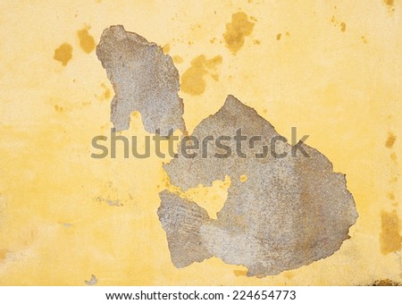 Peeling paint on yellow wall  texture.