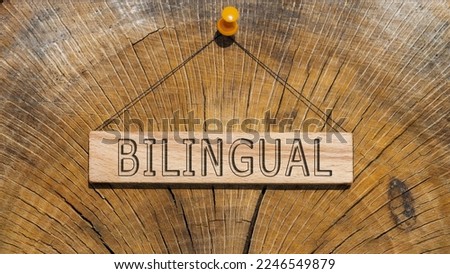 Bilingual written on wooden surface. Wooden Concept.