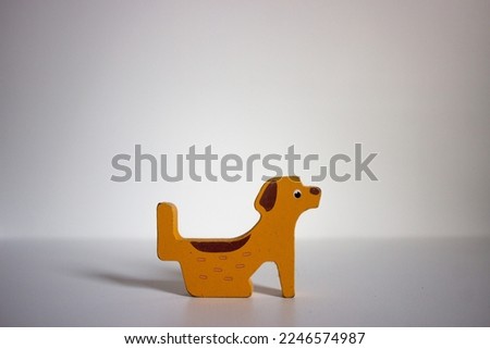 Dog wooden toy isolated in white background