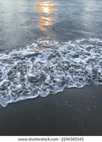 waves on the beach with sunset