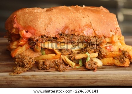 masala steak Gatsby. traditional South African street food made with a large roll and a variety of fillings. Masala steak and chips Royalty-Free Stock Photo #2246590141