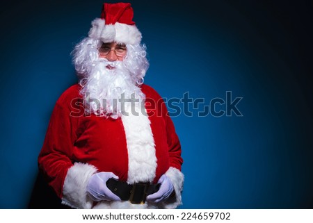 Picture of Santa Claus looking at the camera while holding his black belt.