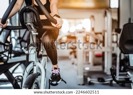 Exercise bike cardio workout at fitness gym.Asian women doing sport biking in the gym for fitness in the morning.Fitness,Gym ,healthy lifestyle concepts. Royalty-Free Stock Photo #2246602511